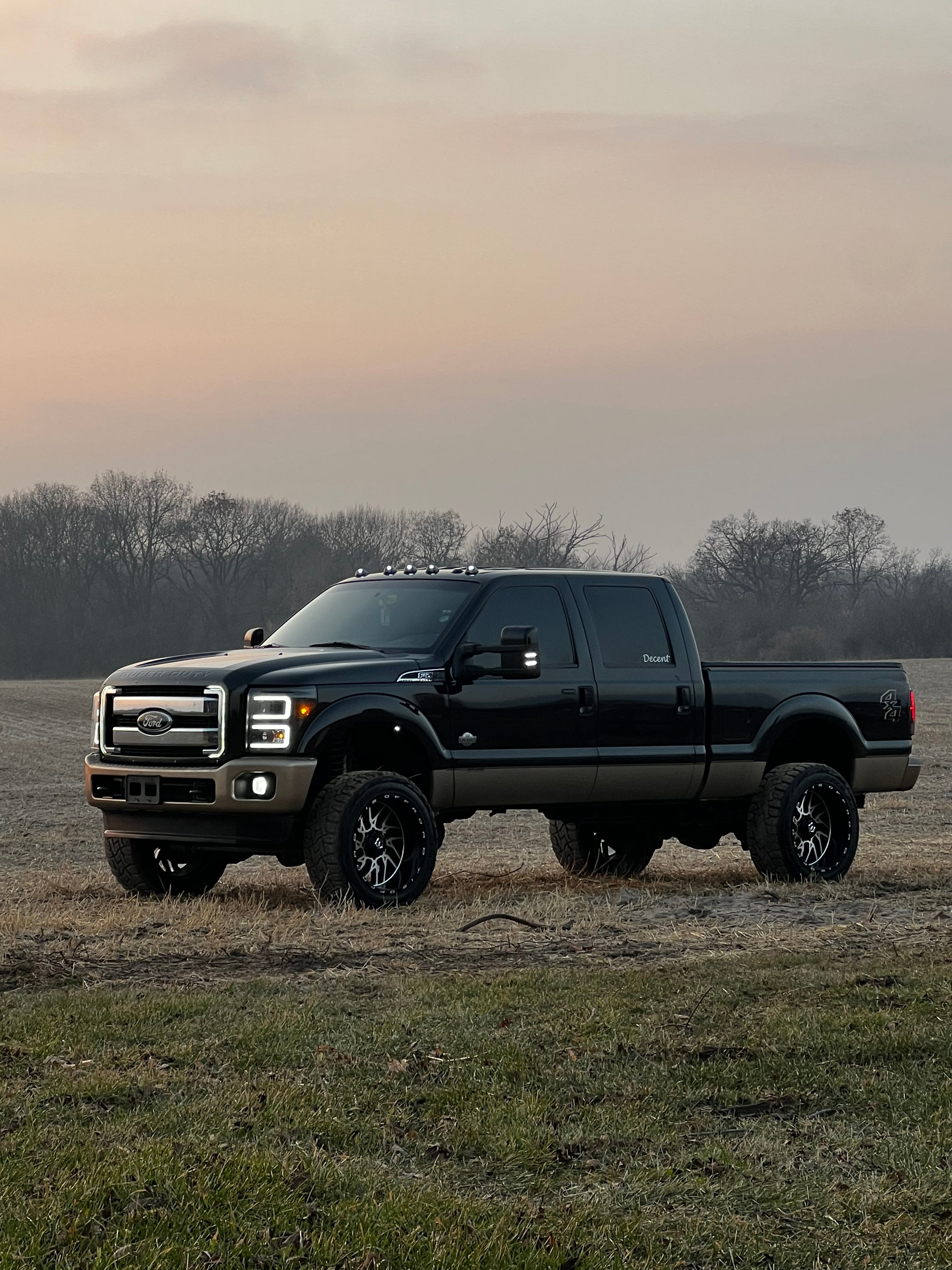 black ford pickup truck with c bar grill lights outside